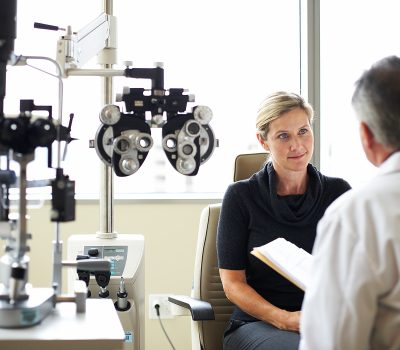 A woman listens to her opthamologist